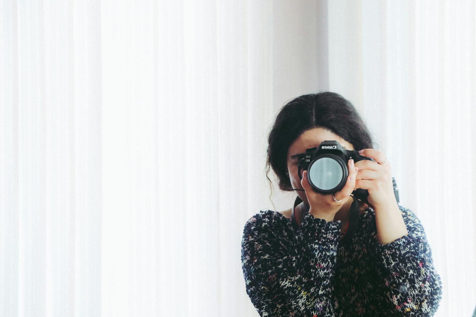 woman in black long sleeved shirt using camera